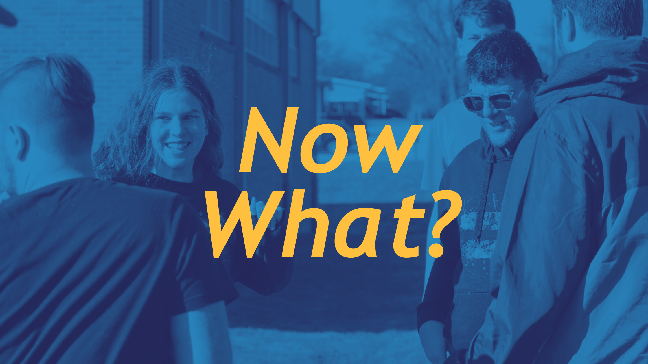 Young adults standing outside in a group with text that reads "now what?"